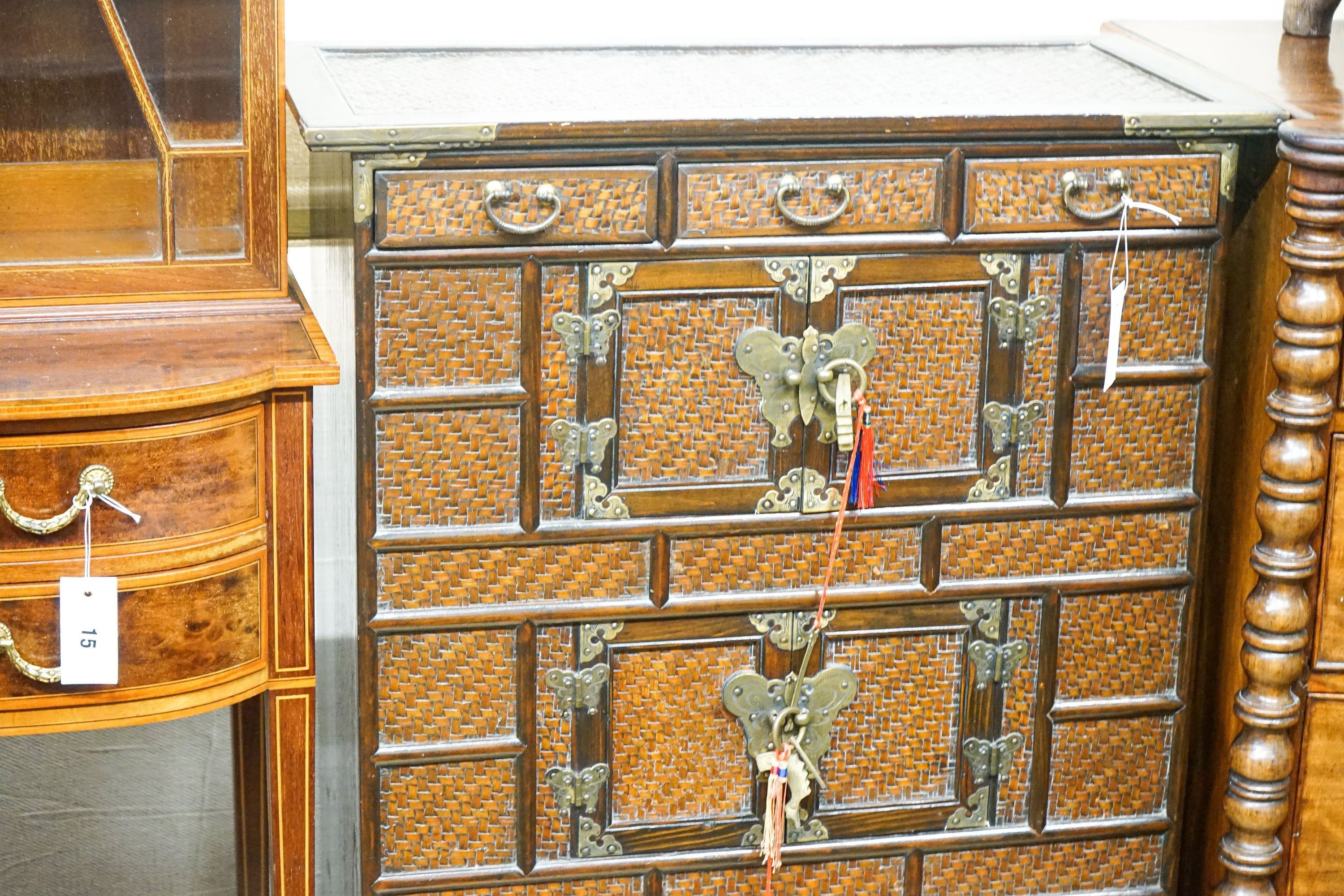 A 20th century Chinese stained wood and rattan side cabinet, width 67cm, depth 32cm, height 104cm